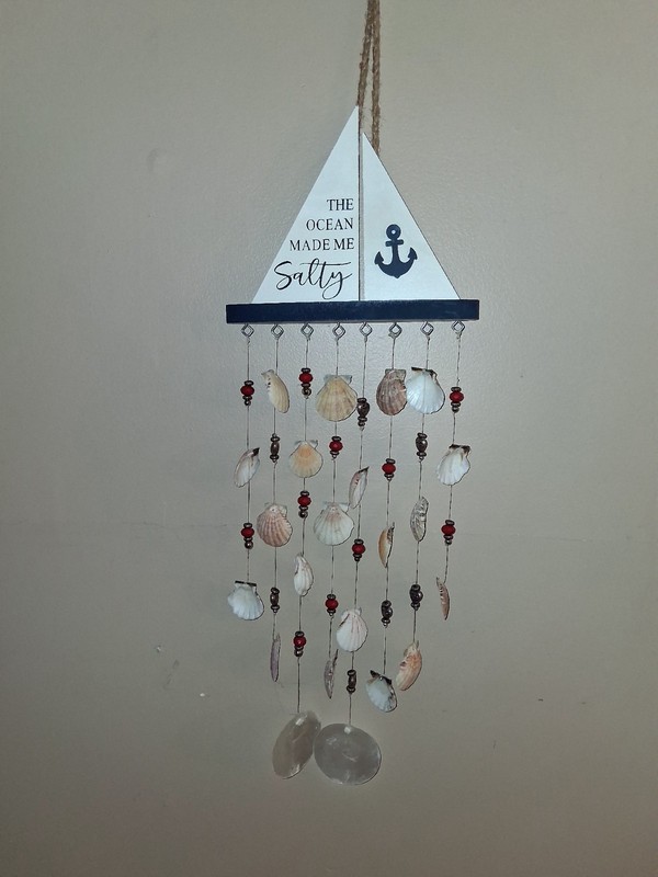 BEACH THEME DECOR. FEATURES A SAIL BOAT WITH HANGING BEADS AND SEA SHELLS.
